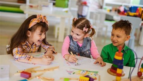 Happy Kids Talking While Drawing In Preschool Starting A Daycare