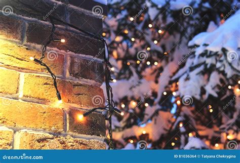 Brick Wall Christmas Background With Lights Glowing And Snow Stock