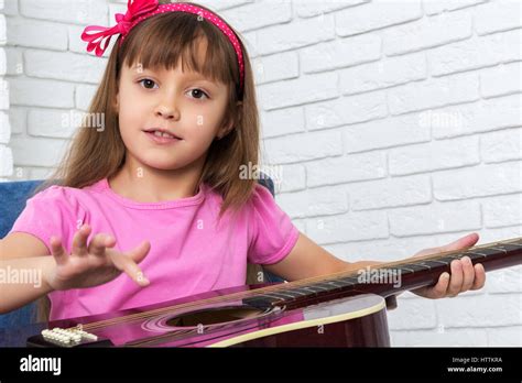 Little Girl Playing The Guitar Stock Photo Alamy