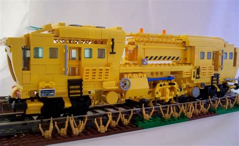 A Lego Train Is Sitting On Top Of The Tracks And Ready To Be Built Into