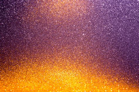 Abstract Background Filled With Shiny Gold And Purple Glitter Stock