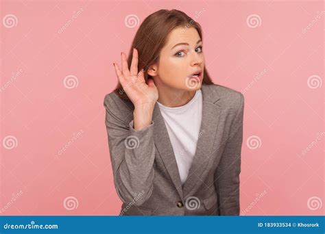 Portrait Of Curious Nosy Young Woman In Business Suit Holding Hand Near