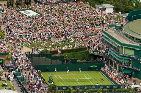 Vintage tennis rackets and slazenger wimbledon tennis ball on grass tennis court. A view of Court 19 and the Hill at Wimbledon - Bob Martin ...