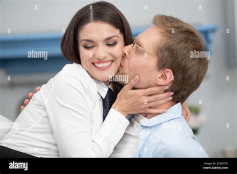 Man Kissing His Smiling Wife On Cheek Cheerful Beautiful Woman With Her Eyes Closed Being