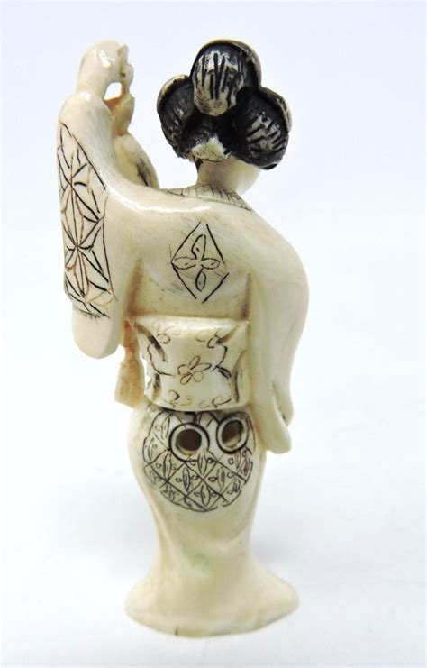 signed hand carved asian netsuke of japanese woman in a kimono holding a scroll with her left