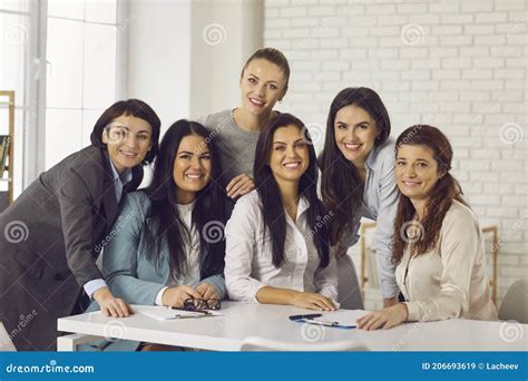 Group Portrait Of Happy Young Business Women Smiling At Camera During