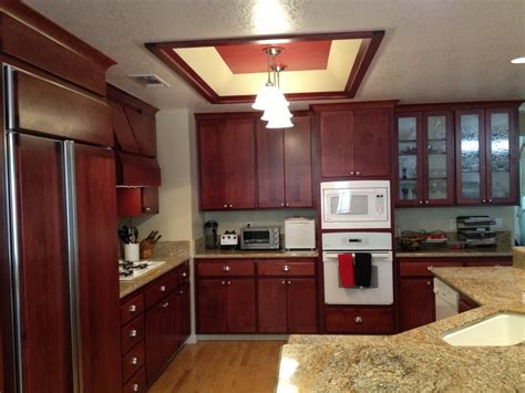 They are highly resistant to heat and moisture while their materials are strong and durable. Cherry wood kitchen cabinets - resurfacing project ...