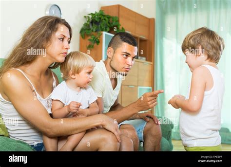 Young Parents Scolding Little Daughter At Home Focus On Little Girl