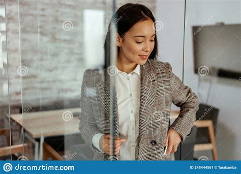 Portrait Of Attractive Asian Business Woman Standing In Modern Office