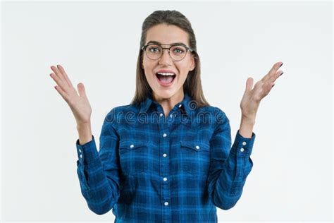 Excited Woman With Glasses Raises Hands With Enjoyment Stock Image