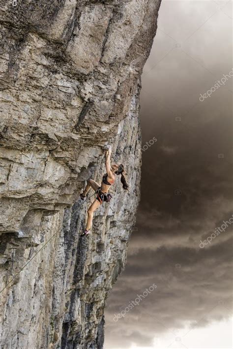 Rock Climber Clinging To A Cliff Stock Photo By ©gregepperson 97386658