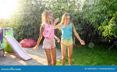 Image Of Two Happy Laughing Teenage Girls Jumping And Dancing Under