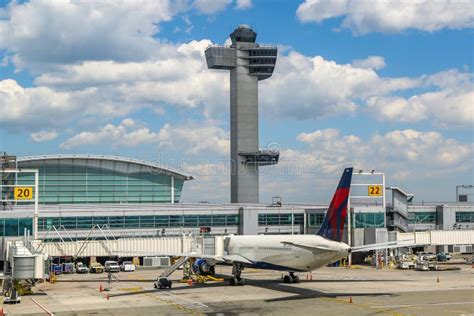 Air Traffic Control Tower And Delta Airlines Plane On Tarmac At