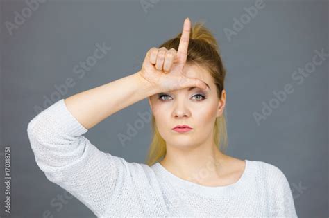 Woman Showing Loser Gesture With L On Forehead Stock Photo Adobe Stock