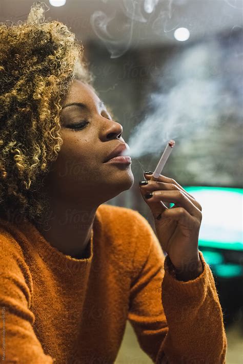 Brazilian Woman Smoking A Cigarette At Home By Stocksy Contributor Mauro Grigollo Stocksy
