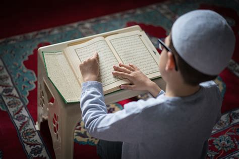 Muslim Boy Reading The Holy Koran In Mosque Stock Photo Download