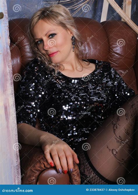 Portrait Of Beautiful Blonde Photomodel In Black Minidress And Black Stockings Stock Image