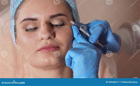 Facial Injection Female Patient And Doctor With Syringe Of Botox Stock