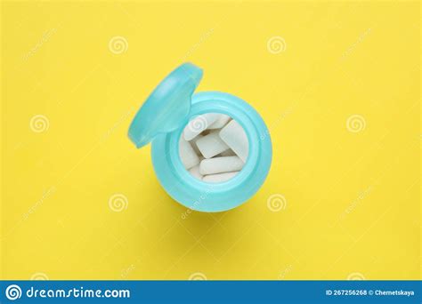 Jar With Chewing Gums On Yellow Background Top View Stock Photo