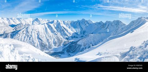 Wide Panoramic View Of Winter Landscape With Snow Covered Alps In