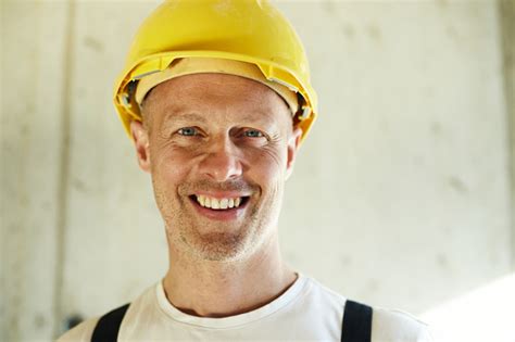 Portrait Of Happy Construction Worker With Hardhat Stock Photo
