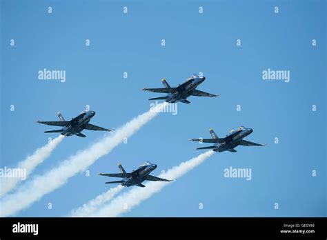 Four United States Navy Blue Angels Fa 18 Hornets Flying In Formation