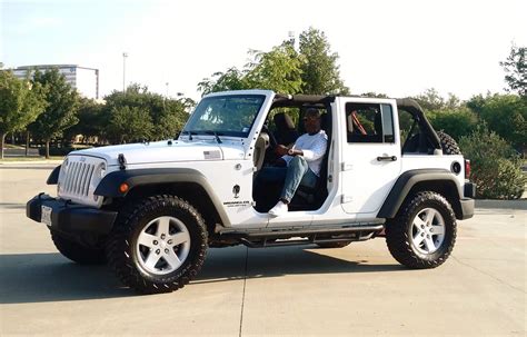White Jeep Wrangler Unlimited With Top And Front Doors Off A Photo On
