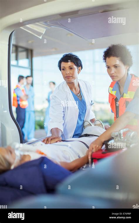 Doctor And Paramedic Examining Patient In Ambulance Stock Photo Alamy