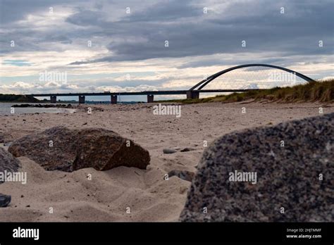 Sandy Beach On The Baltic Sea With Fehmarnsund Bridge In The Background
