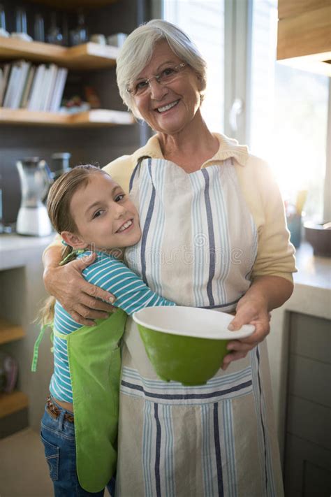 Grandmother And Granddaughter Embracing In The Kitchen Stock Image Image Of Domicile Hugging