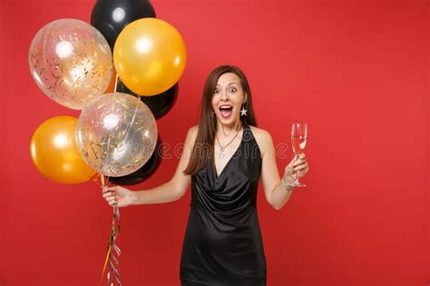 Excited Shocked Young Woman In Black Dress Celebrating Holding Glass Of Champagne Air Balloons