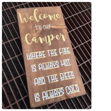 A Wooden Sign That Says Welcome To Our Camper Where The Fire Is Always