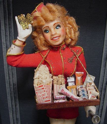 A Doll Is Holding A Tray Full Of Candy And Candies In Its Hands