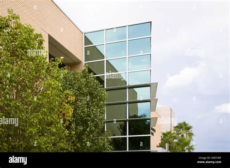 Glass Building Reflects Cloudy Sky At Central Florida Community College