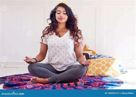 Beautiful Indian Woman Doing Yoga Exercises At Home Padmasana Or