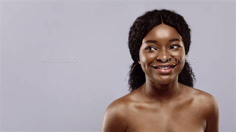 Portrait Of Beautiful Naked African Woman With Flawless Skin Over Grey