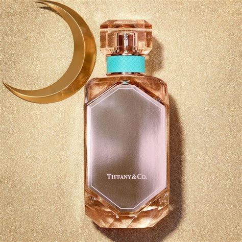 A Bottle Of Tiffany And Co Perfume Next To A Crescent