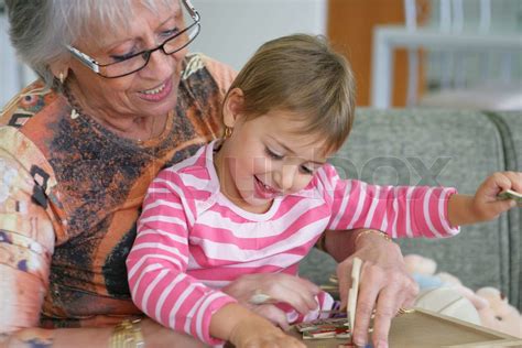 Grandma And Granddaughter Playing A Game Stock Image Colourbox