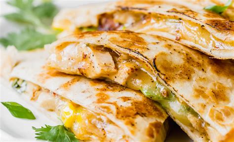 Flake chicken and mix with tomatoes and chiles, and shredded cheese in a bowl. Easy Chicken Quesadilla Recipe - Busy Cooks