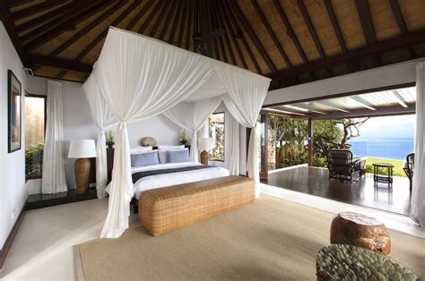 The big glass windows lead to a plush bedroom space. Villa Nora | Ungasan, Bali | Indonesia