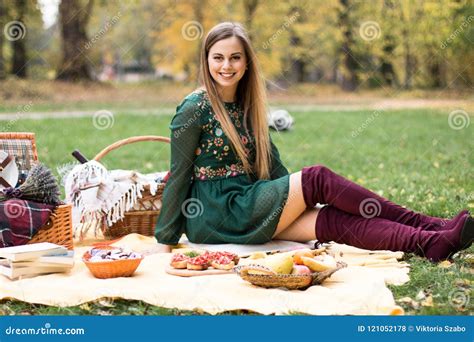 Portrait Of A Pretty Blonde Young Woman Having Picnic In The Park Stock
