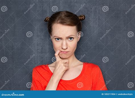 Portrait Of Upset Disappointed Cute Girl Holding Finger In Mouth Stock