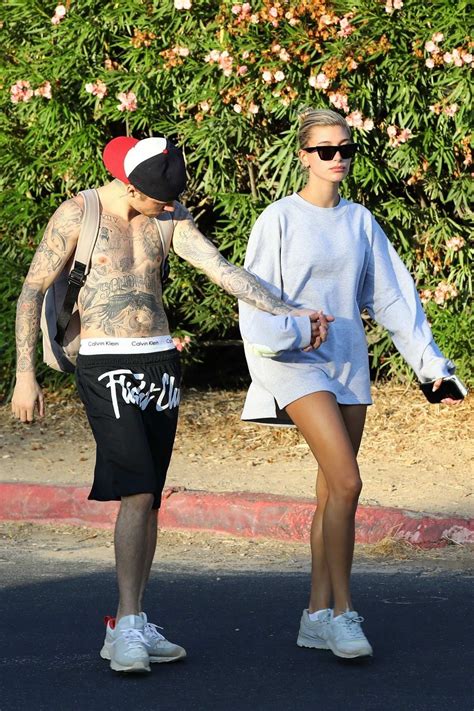 hailey baldwin and justin bieber hold hands as they enjoy a hike in hollywood california