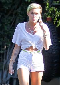 Miley Cyrus Puffs On Cigarette In Crop Top And Shorts As She Puts