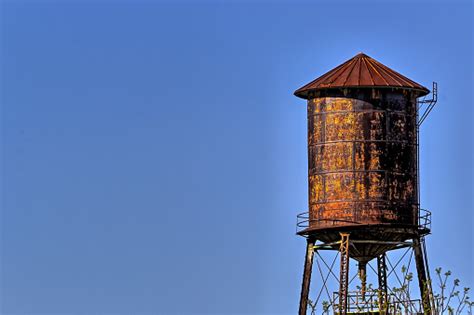 Old Rustic Water Tower With Blue Sky Background Stock Photo Download