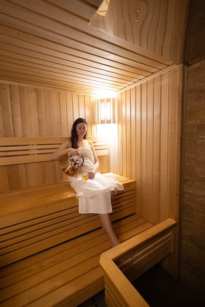 Premium Photo Young Woman Relaxing And Sweating In Hot Sauna Wrapped