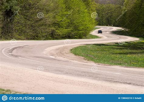 A Car On A Winding Road In A Forest Stock Photo Image Of Green Road