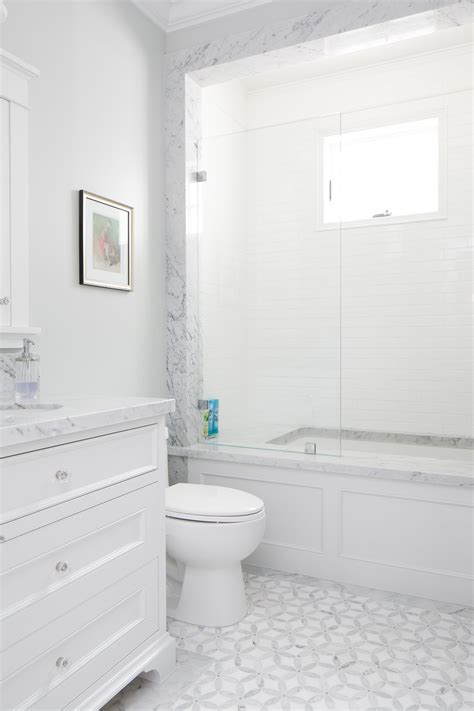 This White Bathroom Features A Unique White And Gray Tile Pattern A Stone Slab Counter Top And