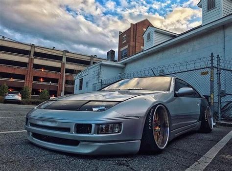 A Silver Sports Car Parked In Front Of A Building