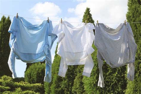 Clean Clothes Hanging On Washing Line In Garden Drying Laundry Stock